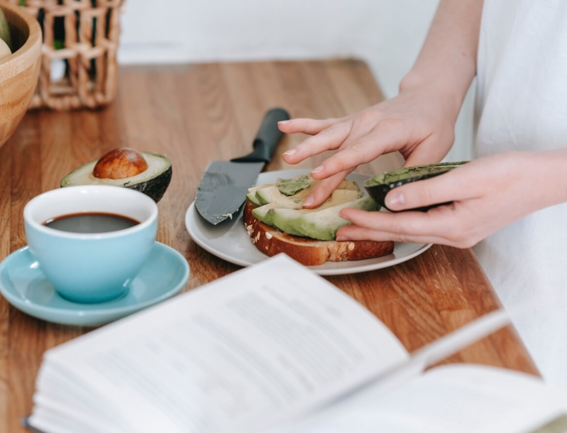 person making avocado toast